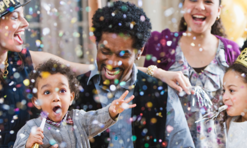 child smiling at confetti 