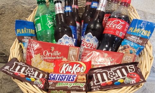 Basket of beer, pop, candy, and popcorn