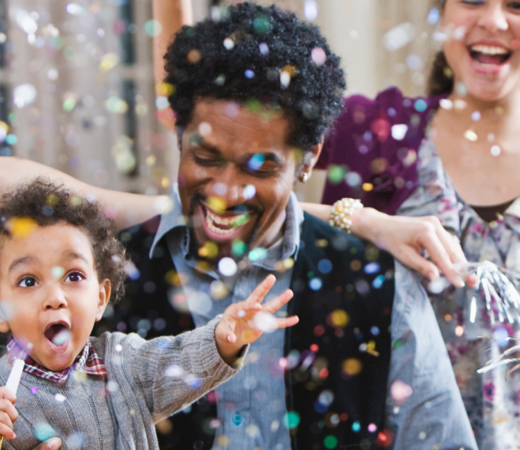 child smiling at confetti 