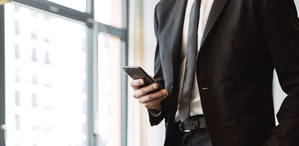 Man in a suit holding a cell phone
