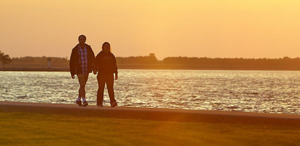 A couple walking at sunset